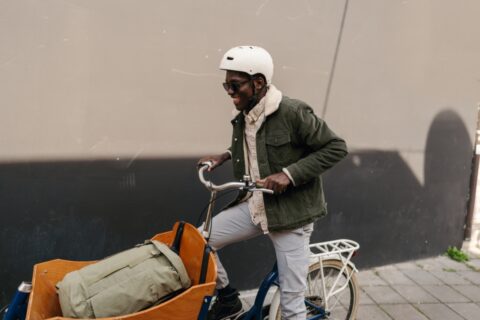 Man riding a cargo bike transporting a bag